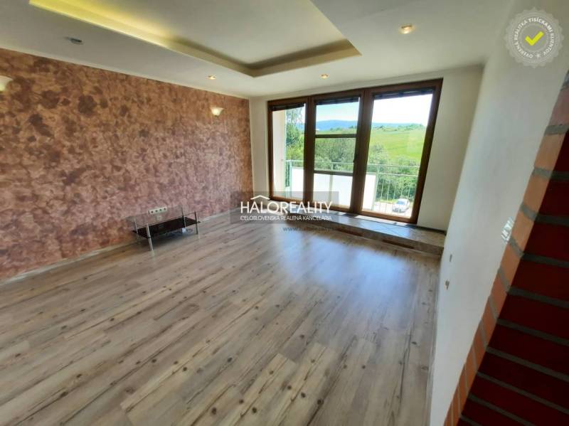 Living room in a 4-room apartment with large windows and wooden flooring.