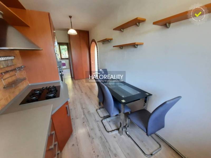 A kitchen with tables and shelves in a 4-room apartment, wooden cabinets.