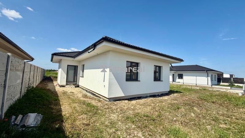 Family house in Mostová, street unspecified, with a white facade and a black roof.