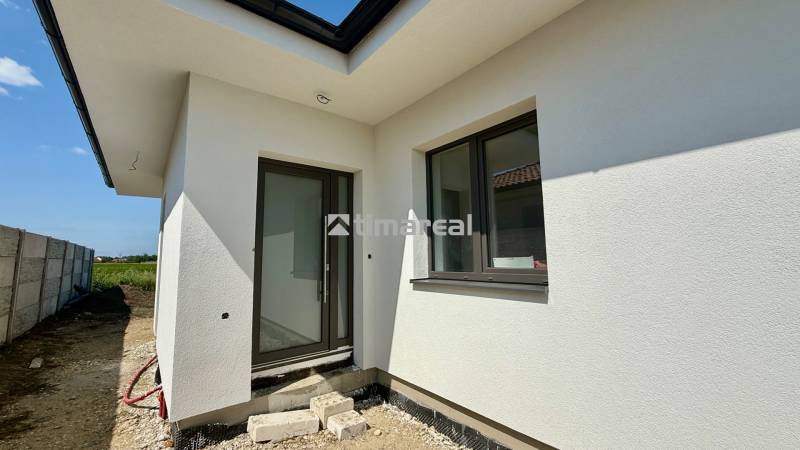 Entrance to a family house in Mostová with stylish windows and a white facade.
