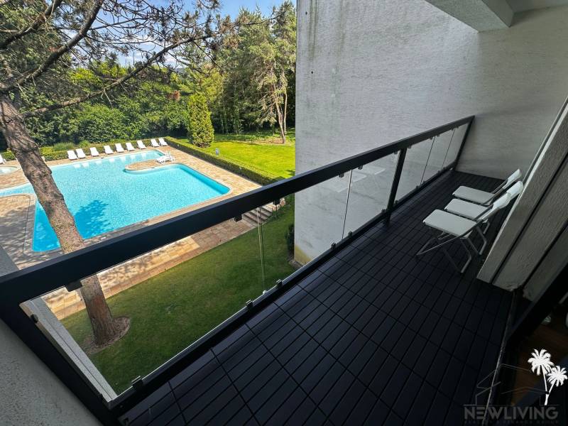 Balcony of a 2-room apartment with a view of the pool and green surroundings in Piešťany on Rekreačná.