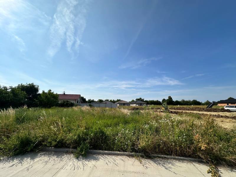 Lands - housing in Slovenská Nová Ves with a view of houses and a vehicle.