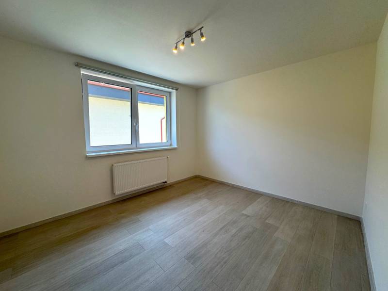 A bright room with a window and wooden floor in a 3-room apartment.