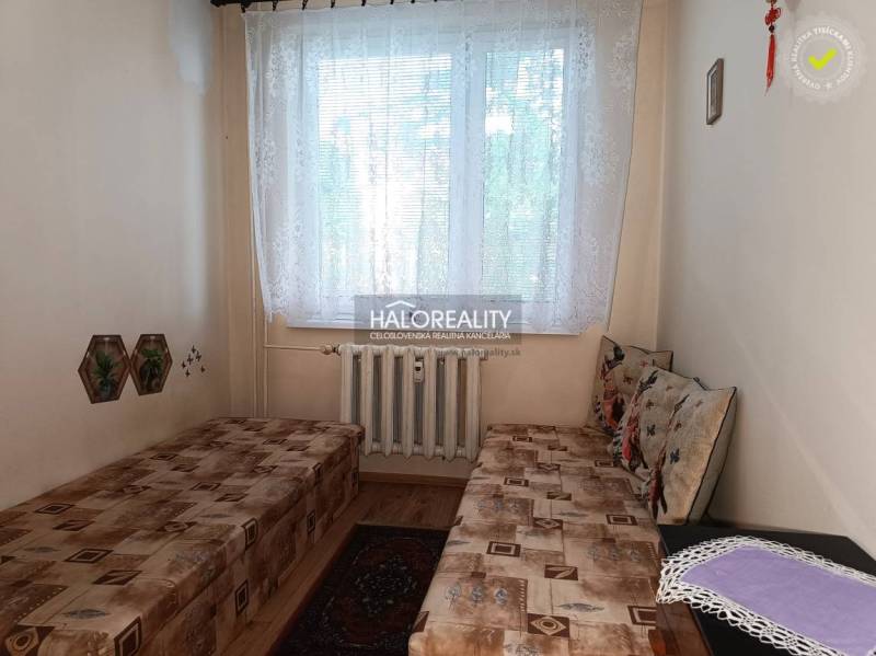 A room with two beds and a radiator in a 3-room apartment.