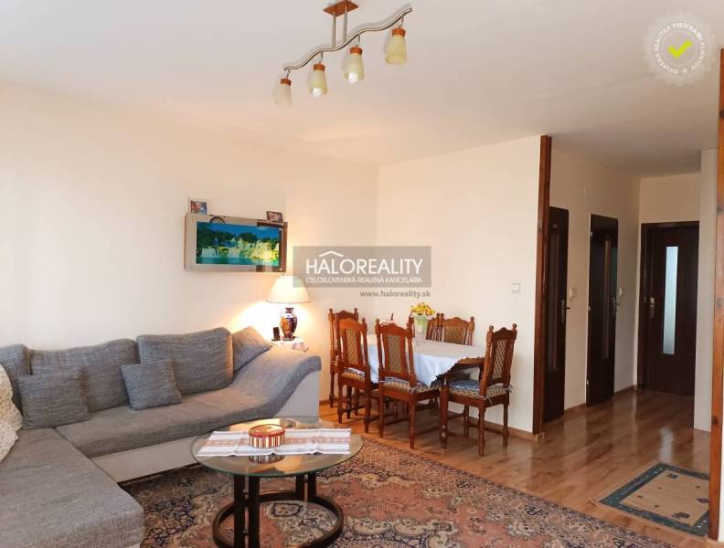 Living room with a sofa and a dining table in a 3-room apartment.