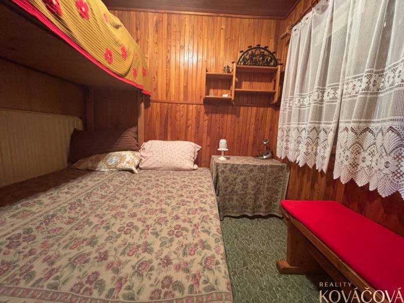 Wooden interior with a bed in a cabin, lace curtain, rustic atmosphere of tranquility.