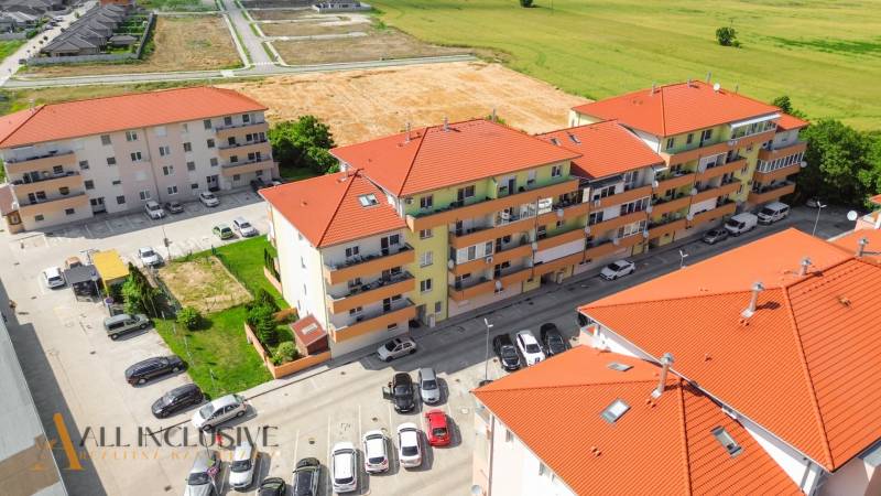 Aerial view of residential buildings on Záhradnícka Street, Dunajská Streda, with a parking lot and land.