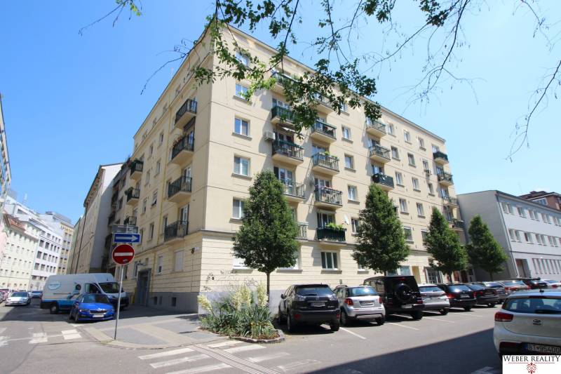 Apartment building on Medená Street in Bratislava - Old Town with a parking lot in front of the building.
