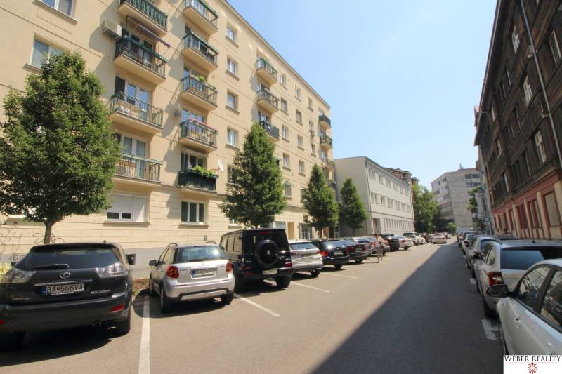A view of apartment buildings and parked cars on Medená Street in Bratislava.