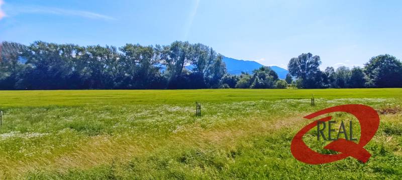 Vast meadows near Podtureň, ideal for residential plots, surrounded by mountains and forests.