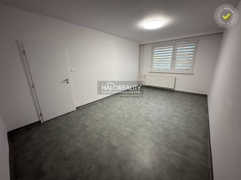 Hallway in a one-room apartment with a white wardrobe and a mirror on the wall.
