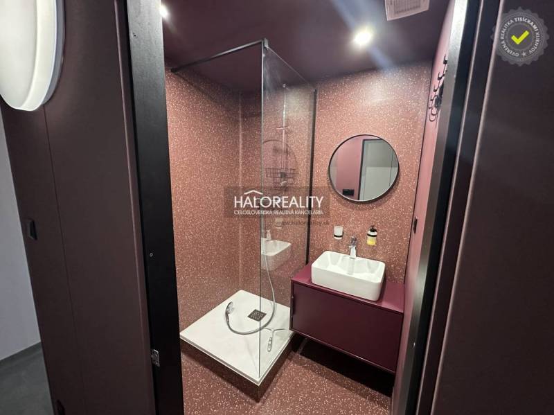 Hallway with a wardrobe and mirror in a studio apartment, light flooring and white walls.