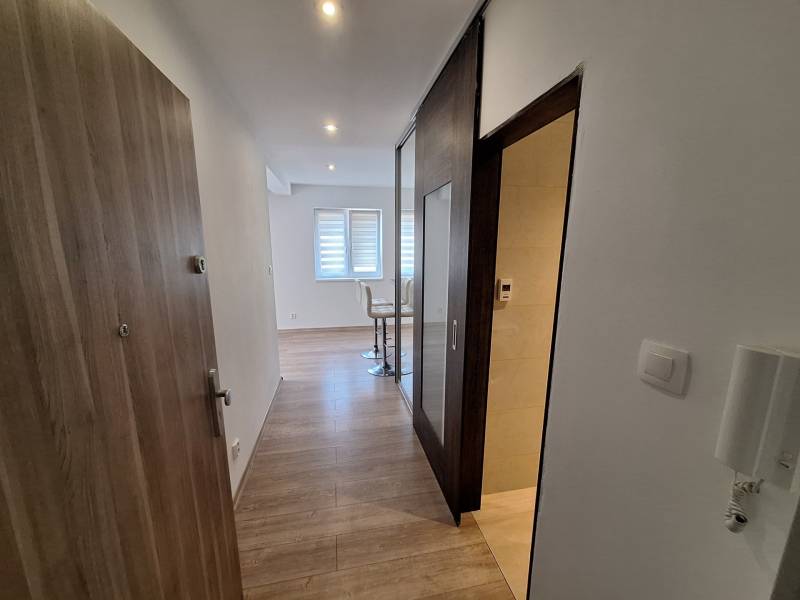 Entrance hall of a 4-room apartment with a bright interior and wooden flooring.