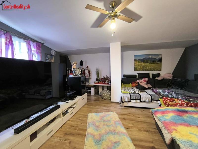 Living room in a family house with a large television and a comfortable sofa.