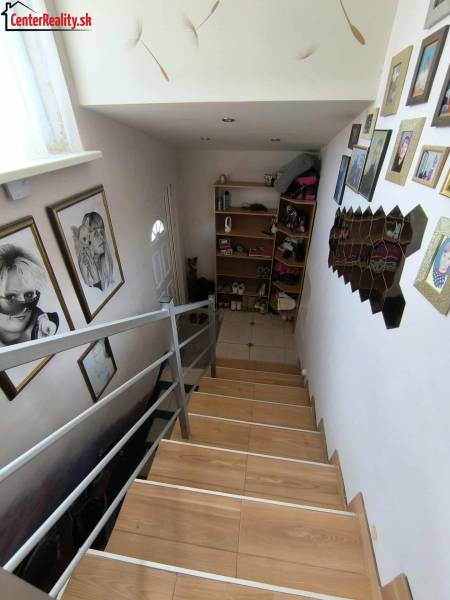 A staircase in a family house with wall decoration and a photo gallery.