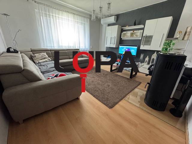 A living room in a family house with a comfortable sofa, modern furniture, and a television.
