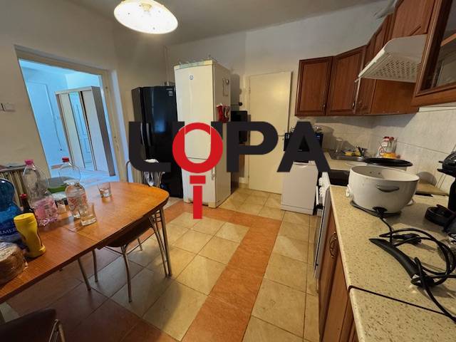 A kitchen in a family house with wooden furniture and appliances.