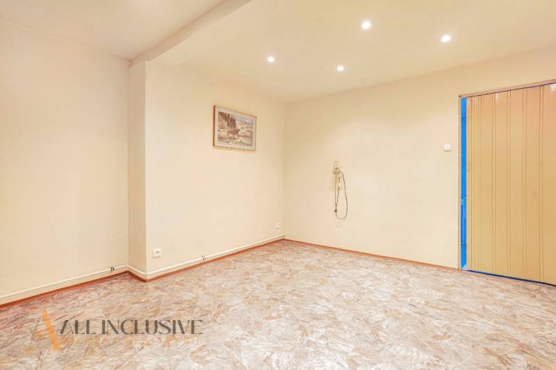 Interior of a family house with an empty room, a picture on the wall, and ceiling lighting.
