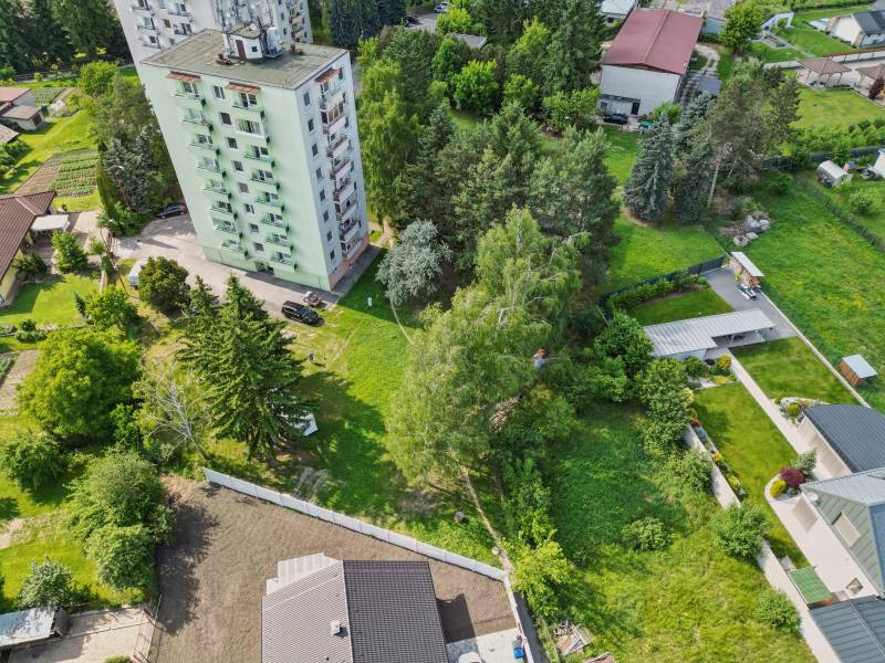 Apartment building surrounded by greenery on Slnečná Street in Kováčová, residential plots.