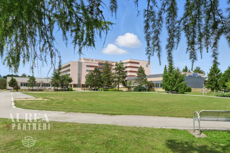 A building with a lawn surrounded by trees on Sunny Street in Kováčová, Land - residential.