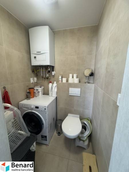 Toilet with washing machine and boiler in a 2-room apartment for rent.