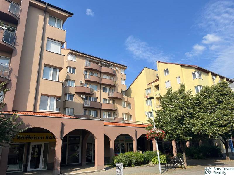 Buildings with commercial spaces on Lichnerova Street in Senec surrounded by greenery.
