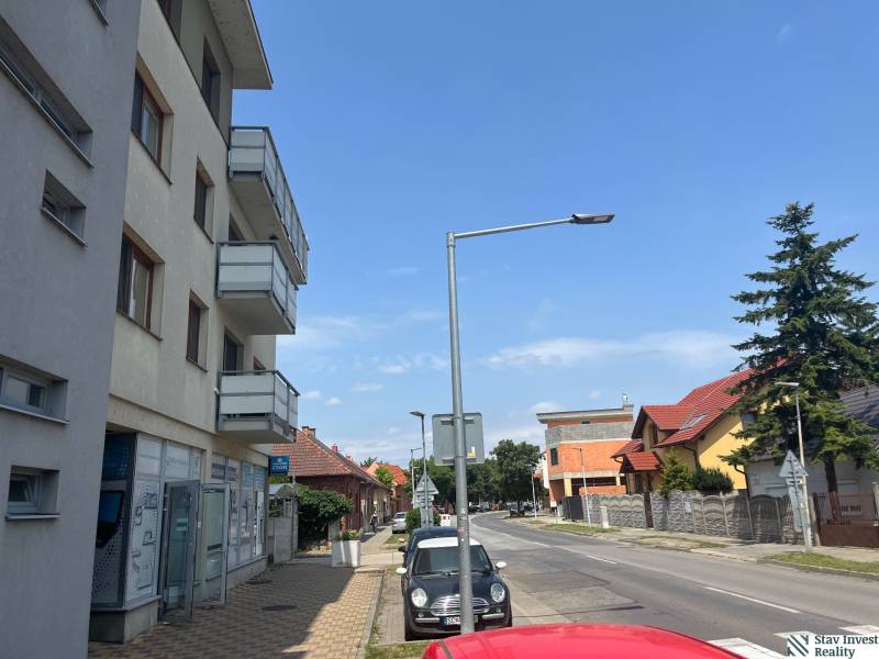 Štúrova Street in Senec with commercial spaces and parked cars.