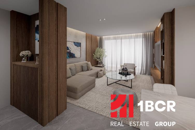 Living room with a sofa and a coffee table in a 3-room apartment, wooden elements dominate.
