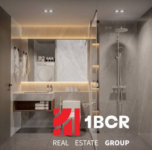 A modern bathroom with a shower and an illuminated mirror in a 3-room apartment.