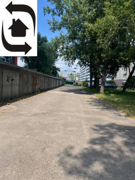 Garages on Budovateľská Street in Bratislava - Ružinov, shown alongside greenery and trees.