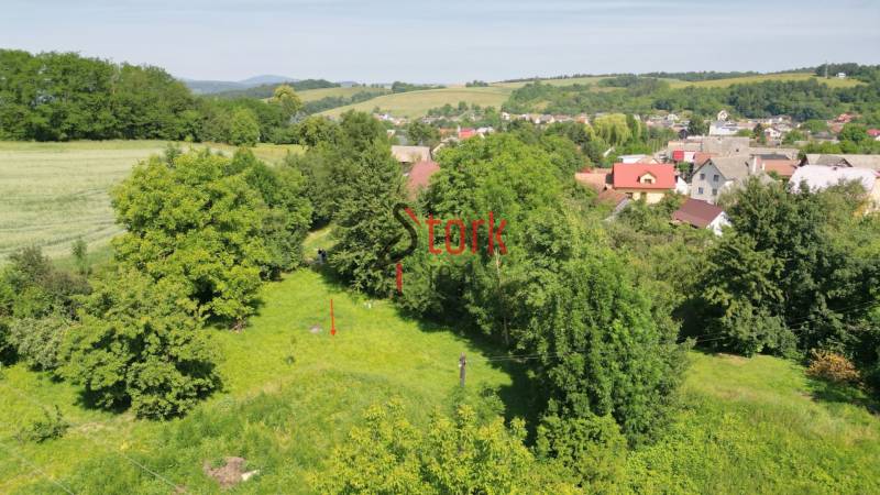 Greenery surrounds residential plots in Visolaje, with visible surrounding houses and landscape.