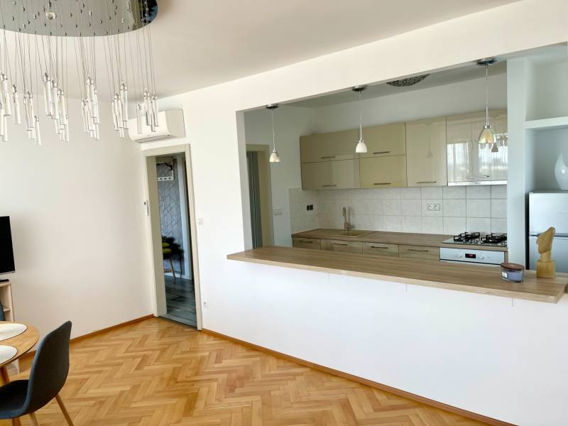 Open-plan kitchen with dining area in a 2-room apartment.