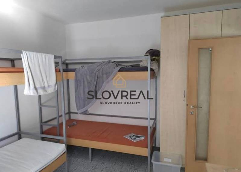 Bunk bed and wardrobes in a 3-room apartment with simple furnishings.