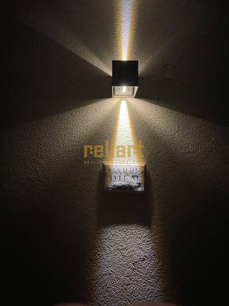 Wall lamp illuminating the inscription 