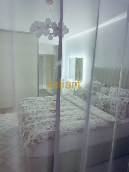 Bedroom in a 3-room apartment with a bed, wardrobe, and mirror.