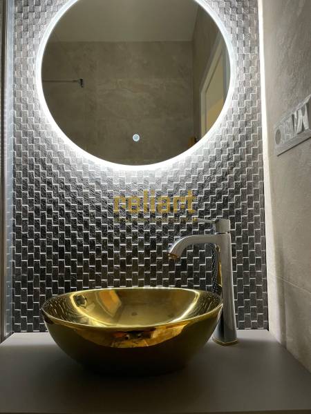 Round backlit mirror and gold sink in a 3-room apartment.