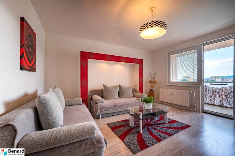 Living room in a 3-room apartment with sofas, a glass table, and a balcony.