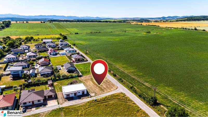 Aerial view of residential plots in Nižná Kamenica with green fields surrounding them.