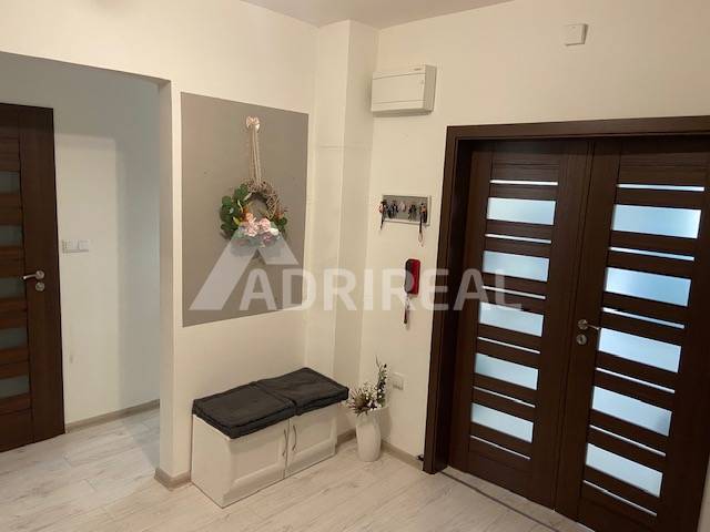Entrance hall in a 3-room apartment with light floors and a shoe cabinet.