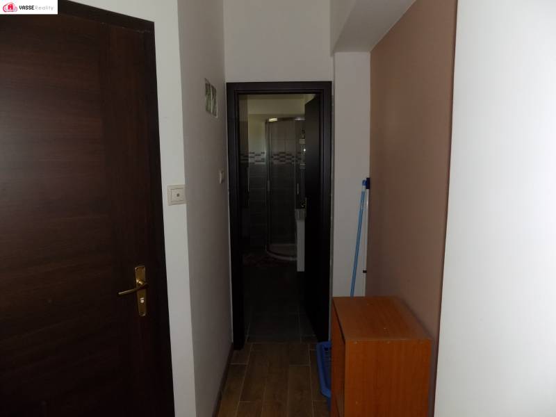 A hallway in a family house with doors leading to the bathroom.