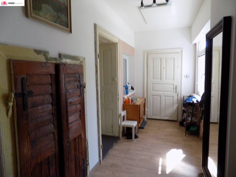 A cozy hallway with wooden doors and furniture in a family house.