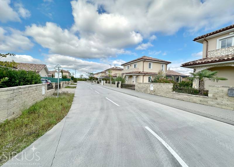 Južná Brána Street in Senec with development for plots - housing, the sky is overcast.