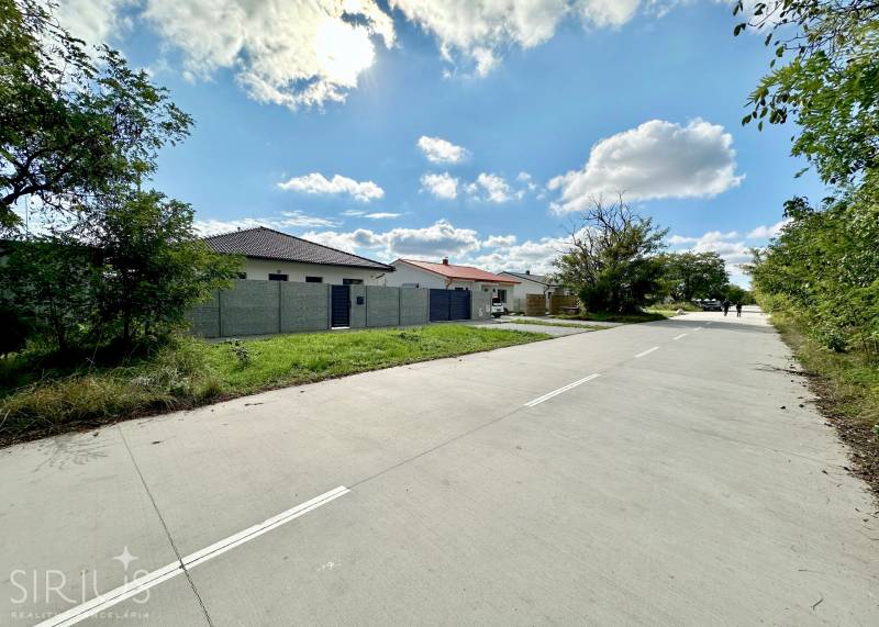 The road at the South Gate in Senec leads by family houses on the plots - residential area.