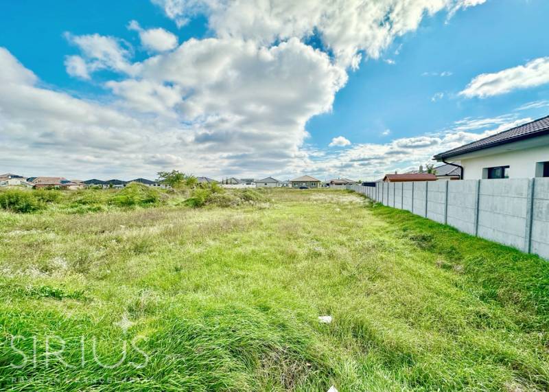 Residential plots at Južná Brána in Senec with grassy area and blue sky.