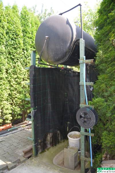 In Trstín, near a family house, we see a water tank with an outdoor shower.