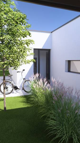 A family house in Gaboltov with a lawn, a bicycle, and ornamental grasses by the wall.