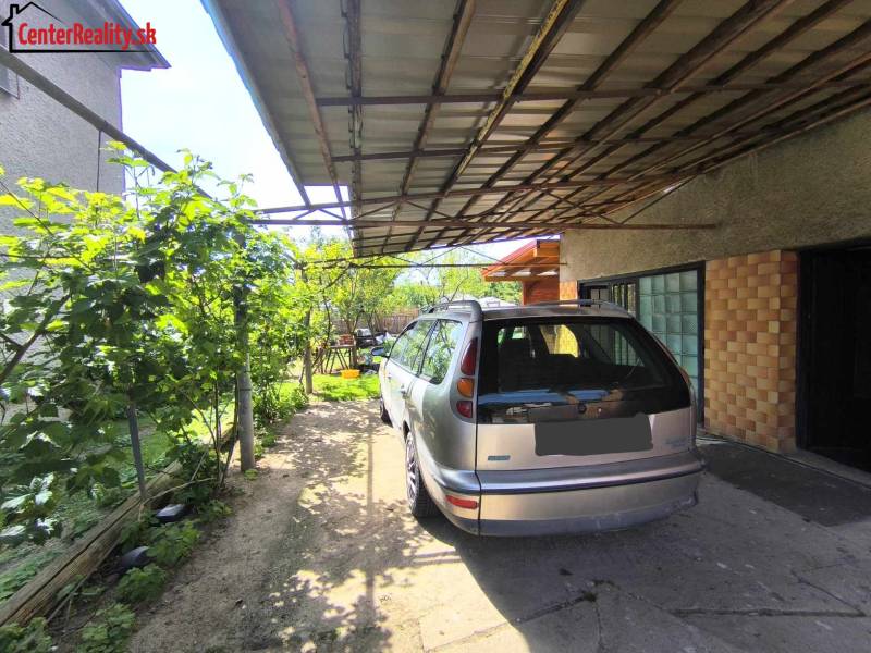 A car parked by a family house on the street in Partizánske, Malé Bielice area.