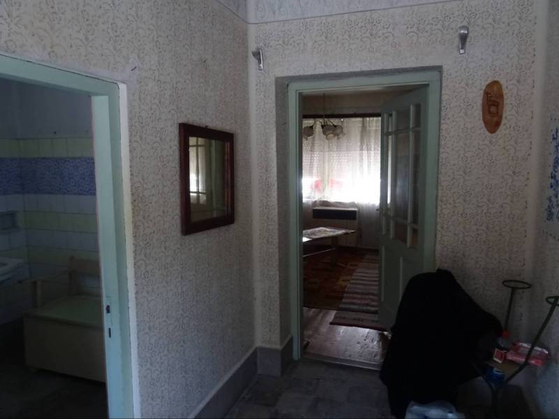 Hallway in a family house with access to the bathroom and living room.