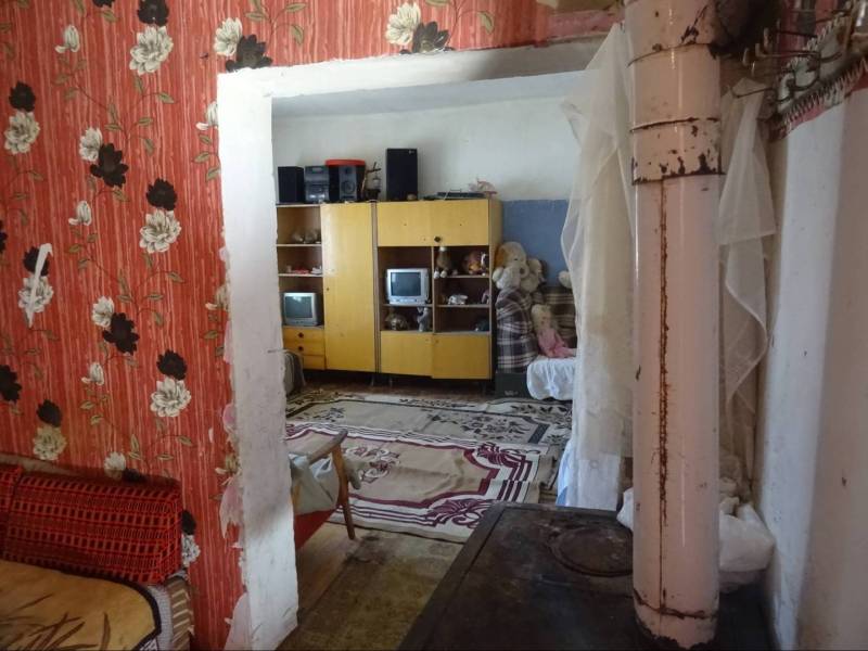 Interior of a family house with colorful wallpapers and rustic accessories.