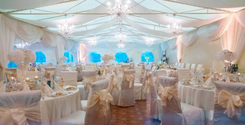 Banquet hall with white decorative elements and floral arrangements, Hotels and guesthouses.